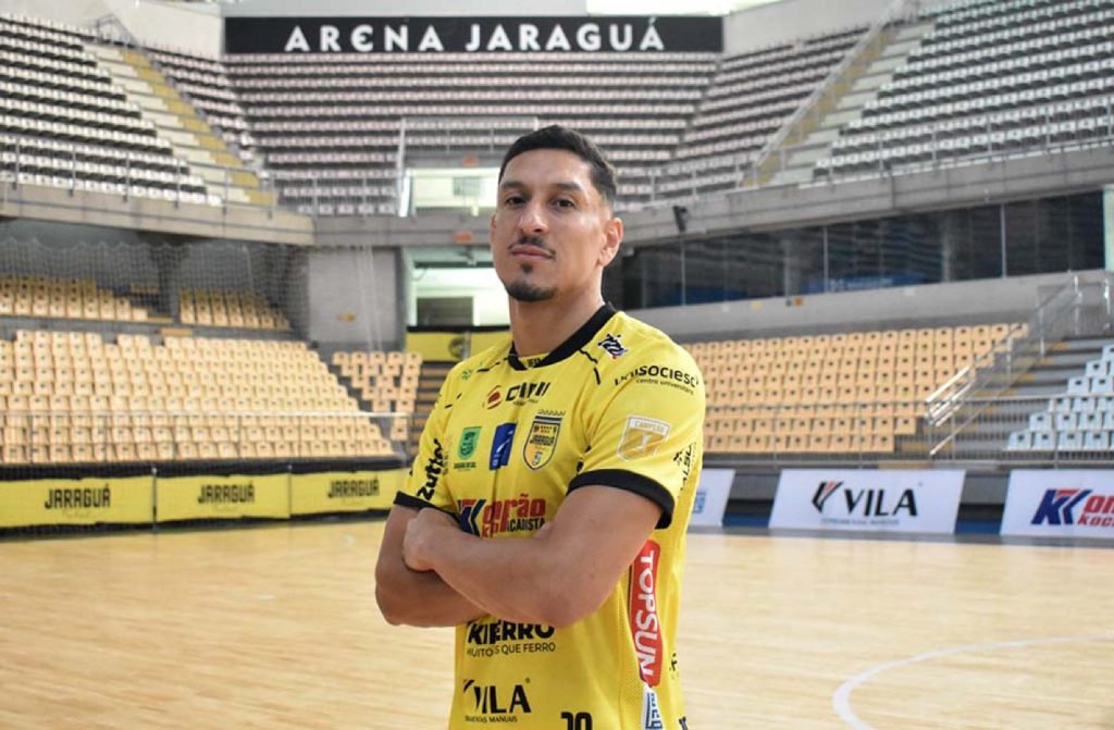 O pivô Nattan Soares posa de braços cruzados com a camisa do Jaraguá, na Arena Jaraguá