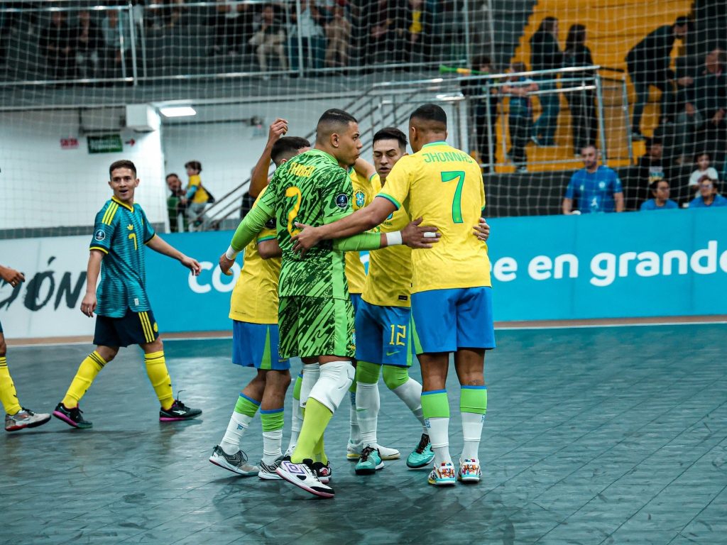 Jogadores do Brasil, de camisa amarela, comemoram juntos, com o goleiro de uniforme verde, em jogo da CONMEBOL Liga Evolução